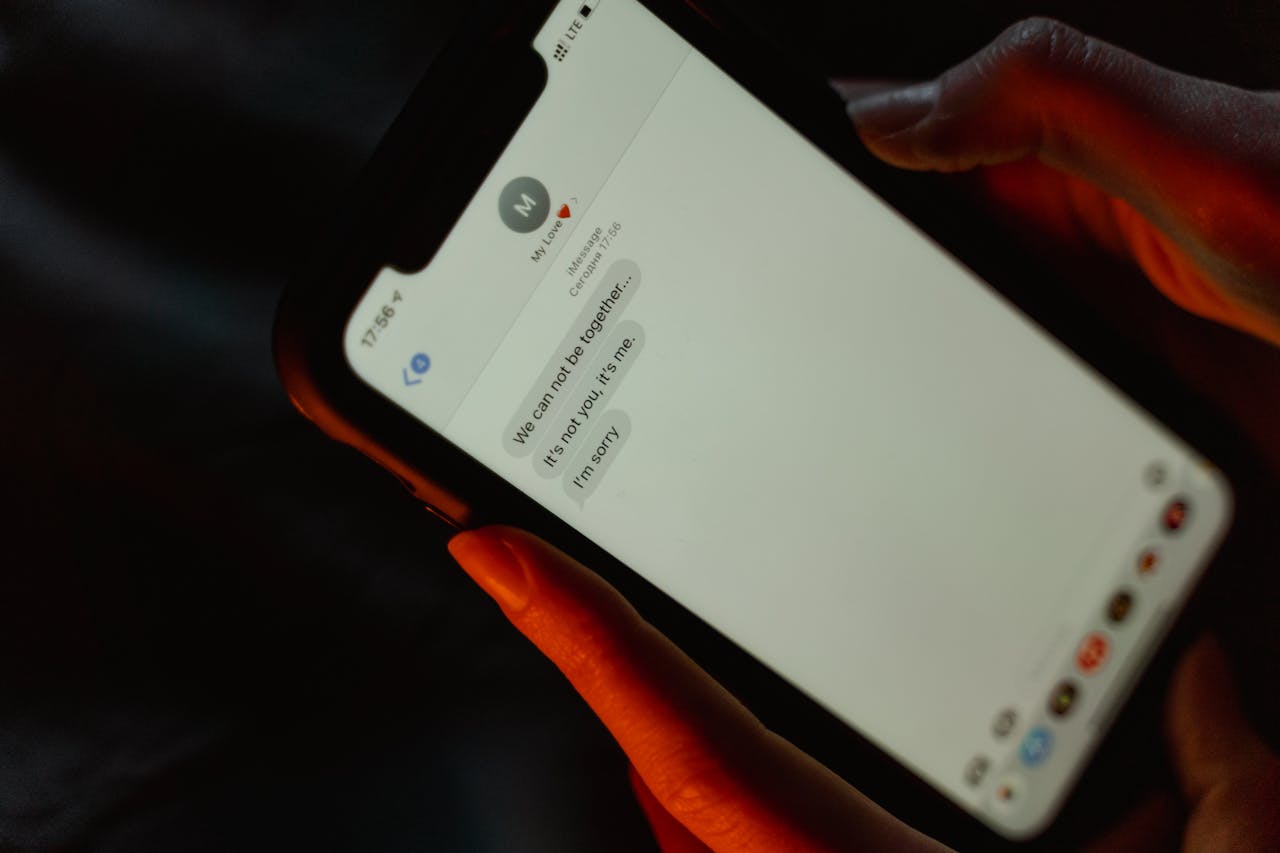 services-01 A close-up view of a text message on a smartphone screen displaying a breakup message.